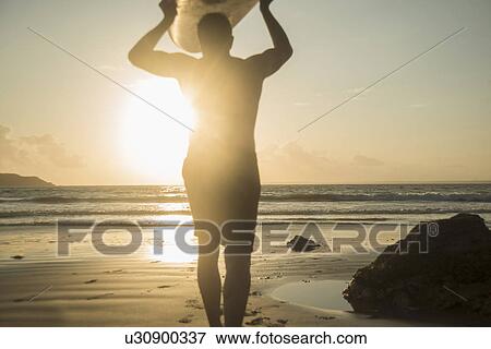 Mature man, walking towards sea, holding surf board View Large Photo Image Stock Photo - Mature man, walking towards sea, holding surf board. Fotosearch