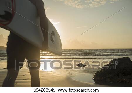 Mature man, walking towards sea, holding surf board View Large Photo Image Stock Photography - Mature man, walking towards sea, holding surf board. Fotosearch