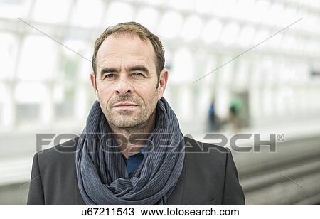 Mature man wearing scarf, portrait View Large Photo Image Stock Image - Mature man wearing scarf, portrait. Fotosearch