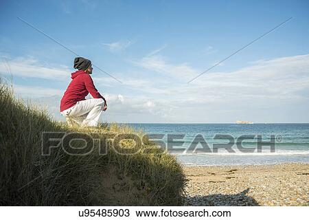 Mature woman crouching and gazing at sea view, Camaret-sur-mer, Brittany, France View Large Photo Image Stock Image - Mature woman crouching and gazing at sea view, Camaret-sur-mer, Brittany, France. Fotosearch