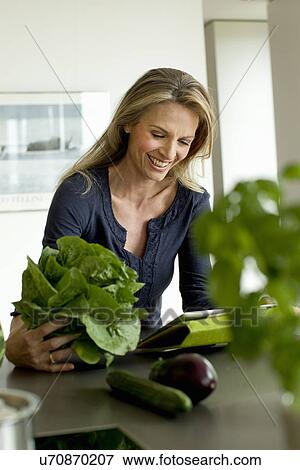 Mature woman holding lettuce View Large Photo Image Stock Photo - Mature woman holding lettuce. Fotosearch