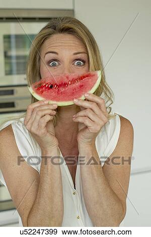 Stock Photo - Mature woman holding watermelon. Fotosearch