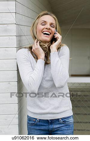 Mature woman on cell phone, laughing View Large Photo Image Stock Photograph - Mature woman on cell phone, laughing. Fotosearch