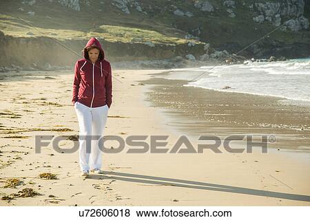 Mature woman strolling on beach with hands in pockets, Camaret-sur-mer, Brittany, France View Large Photo Image Stock Photo - Mature woman strolling on beach with hands in pockets, Camaret-sur-mer, Brittany, France. Fotosearch