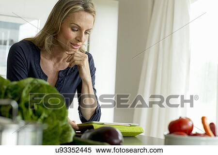 Mature woman using digital tablet View Large Photo Image Stock Photography - Mature woman using digital tablet. Fotosearch