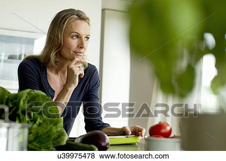 Stock Photo - Mature woman with digital tablet. Fotosearch