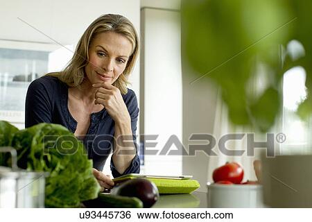 Mature woman with digital tablet View Large Photo Image Stock Photograph - Mature woman with digital tablet. Fotosearch