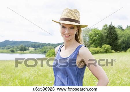 Mid adult woman wearing sunhat, portrait View Large Photo Image Stock Image - Mid adult woman wearing sunhat, portrait. Fotosearch