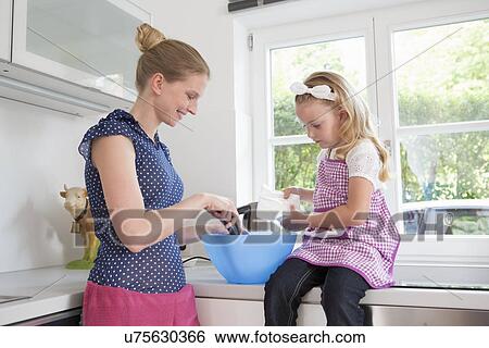 Mother and daughter baking View Large Photo Image Stock Photograph - Mother and daughter baking. Fotosearch
