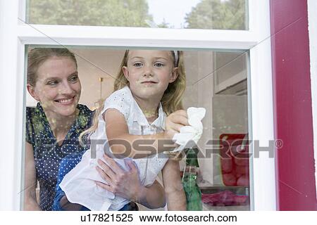 Mother and daughter cleaning window View Large Photo Image Stock Photography - Mother and daughter cleaning window. Fotosearch