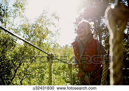 Stock Image - Outdoor sports and adventure tree climbing. Fotosearch