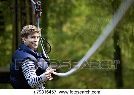 Stock Photo - Outdoor sports and adventure tree climbing. Fotosearch