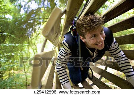Stock Photograph - Outdoor sports and adventure tree climbing. Fotosearch