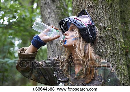 Paintball player drinking from bottle View Large Photo Image Stock Photo - Paintball player drinking from bottle. Fotosearch