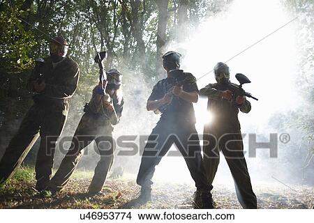 Picture - Paintball players in action. Fotosearch