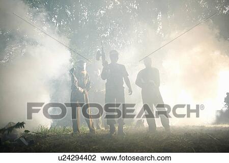 Stock Image - Paintball players in action. Fotosearch