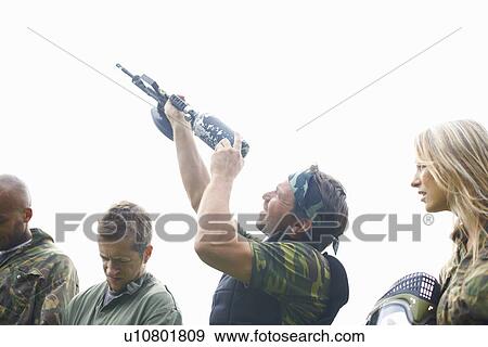 Paintball players preparing and planning game View Large Photo Image Stock Photo - Paintball players preparing and planning game. Fotosearch