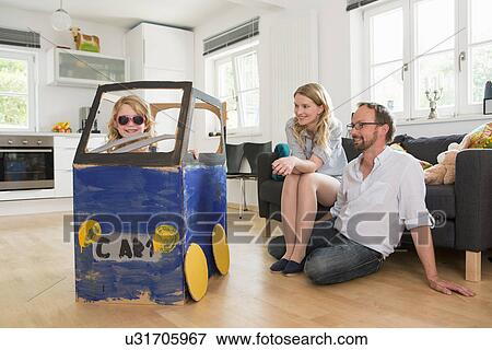 Parents watching daughter in homemade toy car View Large Photo Image Stock Photo - Parents watching daughter in homemade toy car. Fotosearch