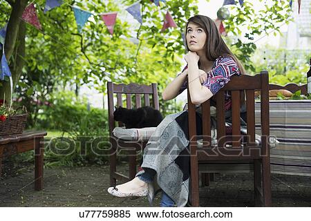 Pensive young woman sitting in garden View Large Photo Image Stock Photography - Pensive young woman sitting in garden. Fotosearch