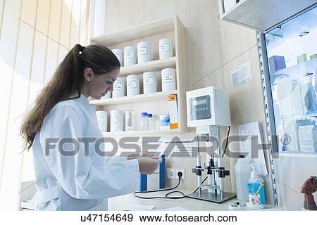 Stock Photo - Pharmacist in pharmacy. Fotosearch