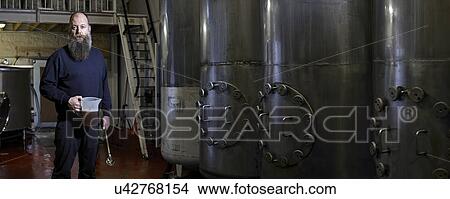 Picture - Portrait of a brewery worker in his working environment. Fotosearch