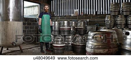 Stock Photo - Portrait of a brewery worker in his working environment. Fotosearch