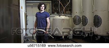 Portrait of a brewery worker in his working environment View Large Photo Image Stock Photo - Portrait of a brewery worker in his working environment. Fotosearch