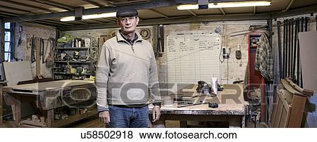 Portrait of a cabinet maker in his working environment View Large Photo Image Stock Photo - Portrait of a cabinet maker in his working environment. Fotosearch