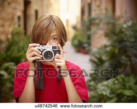Portrait of boy photographing village street using SLR camera, Majorca, Spain View Large Photo Image Stock Photograph - Portrait of boy photographing village street using SLR camera, Majorca, Spain. Fotosearch