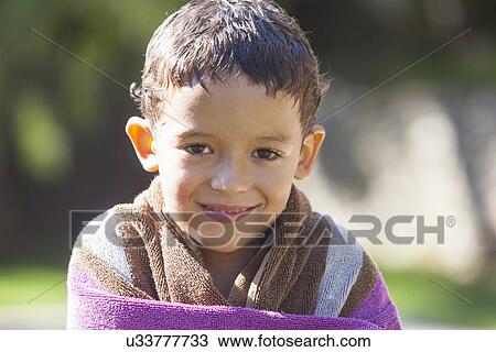Portrait of boy with wet hair wrapped in towel in garden View Large Photo Image Stock Image - Portrait of boy with wet hair wrapped in towel in garden. Fotosearch