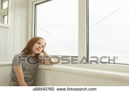 Portrait of girl gazing out of holiday apartment window View Large Photo Image Stock Image - Portrait of girl gazing out of holiday apartment window. Fotosearch