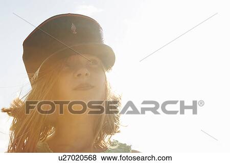 Portrait of girl in cap at sunlit coast View Large Photo Image Stock Photo - Portrait of girl in cap at sunlit coast. Fotosearch