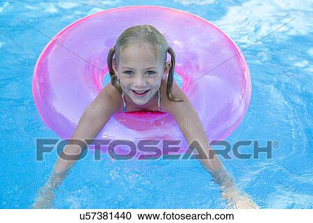 Portrait of girl in inflatable ring in garden swimming pool View Large Photo Image Stock Image - Portrait of girl in inflatable ring in garden swimming pool. Fotosearch