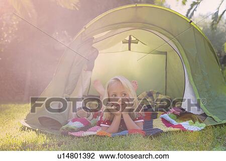 Portrait of girl lying gazing from garden tent View Large Photo Image Stock Image - Portrait of girl lying gazing from garden tent. Fotosearch