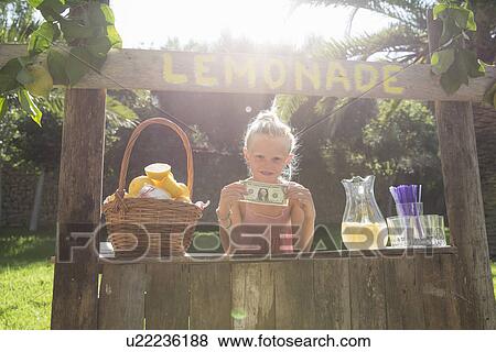 Portrait of girl on lemonade stand holding up one dollar bill View Large Photo Image Stock Photo - Portrait of girl on lemonade stand holding up one dollar bill. Fotosearch