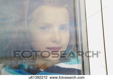 Portrait of girl wrapped in towel gazing from holiday apartment window View Large Photo Image Stock Image - Portrait of girl wrapped in towel gazing from holiday apartment window. Fotosearch