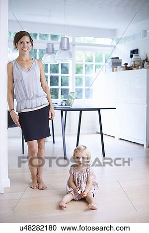 Portrait of mid adult mother and toddler daughter in dining room View Large Photo Image Stock Image - Portrait of mid adult mother and toddler daughter in dining room. Fotosearch