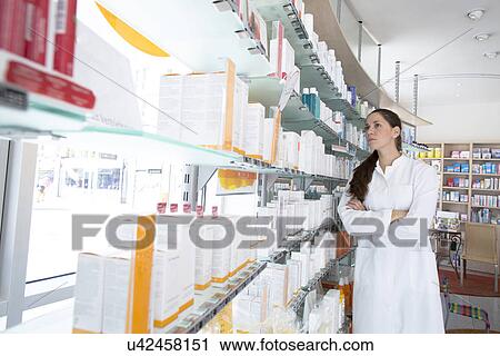 Stock Image - Portrait of pharmacist in pharmacy. Fotosearch