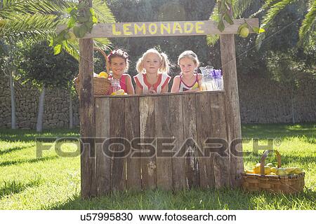 Portrait of three girls selling lemonade at stand in park View Large Photo Image Stock Image - Portrait of three girls selling lemonade at stand in park. Fotosearch