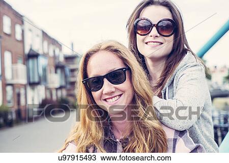 Portrait of two young female best friends in sunglasses View Large Photo Image Stock Image - Portrait of two young female best friends in sunglasses. Fotosearch