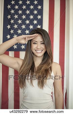 Portrait of woman saluting in front of american flag View Large Photo Image Stock Photo - Portrait of woman saluting in front of american flag. Fotosearch