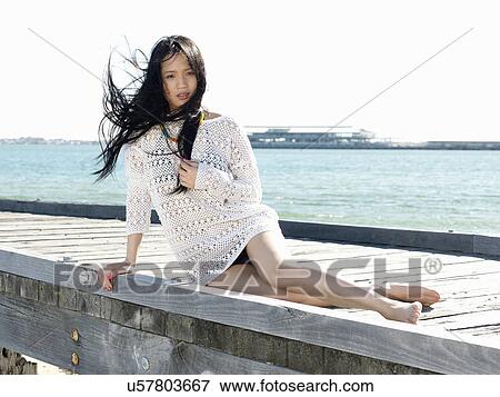 Portrait of young woman reclining on pier, Port Melbourne, Melbourne, Victoria, Australia View Large Photo Image Stock Photo - Portrait of young woman reclining on pier, Port Melbourne, Melbourne, Victoria, Australia. Fotosearch