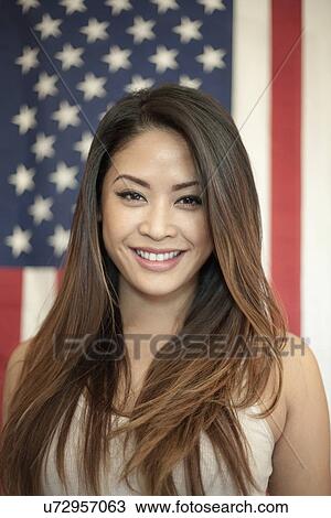 Portrait of young woman standing in front of american flag View Large Photo Image Stock Image - Portrait of young woman standing in front of american flag. Fotosearch