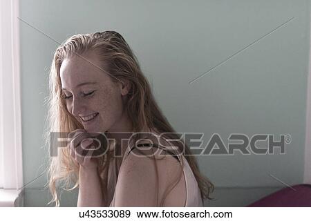 Stock Photo - Portrait of young woman with freckles laughing. Fotosearch