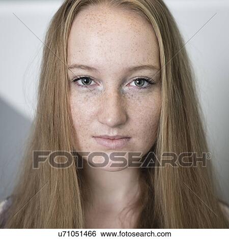 Stock Photograph - Portrait of young woman with freckles. Fotosearch