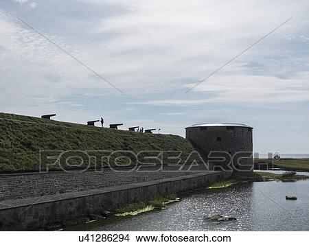 Picture - Row of silhouetted cannons on defensive wall, Oland, Sweden. Fotosearch