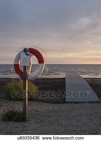 Sea, pier and lifebelt View Large Photo Image Stock Photograph - Sea, pier and lifebelt. Fotosearch