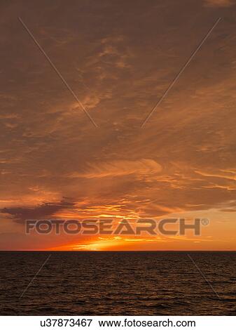 Seascape with sunset over horizon View Large Photo Image Stock Photo - Seascape with sunset over horizon. Fotosearch