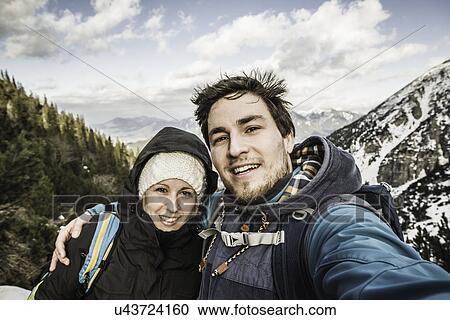 Self portrait of young couple in mountains, Hundsarschjoch, Vils, Bavaria, Germany View Large Photo Image Stock Image - Self portrait of young couple in mountains, Hundsarschjoch, Vils, Bavaria, Germany. Fotosearch