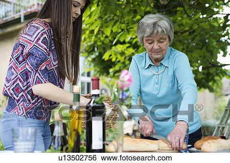 Senior woman cutting bread View Large Photo Image Stock Photograph - Senior woman cutting bread. Fotosearch